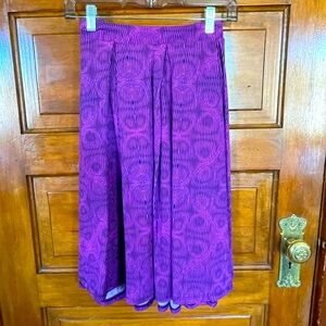 Super cute pink with a purple design skirt with pockets!